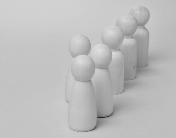 wooden people in a line